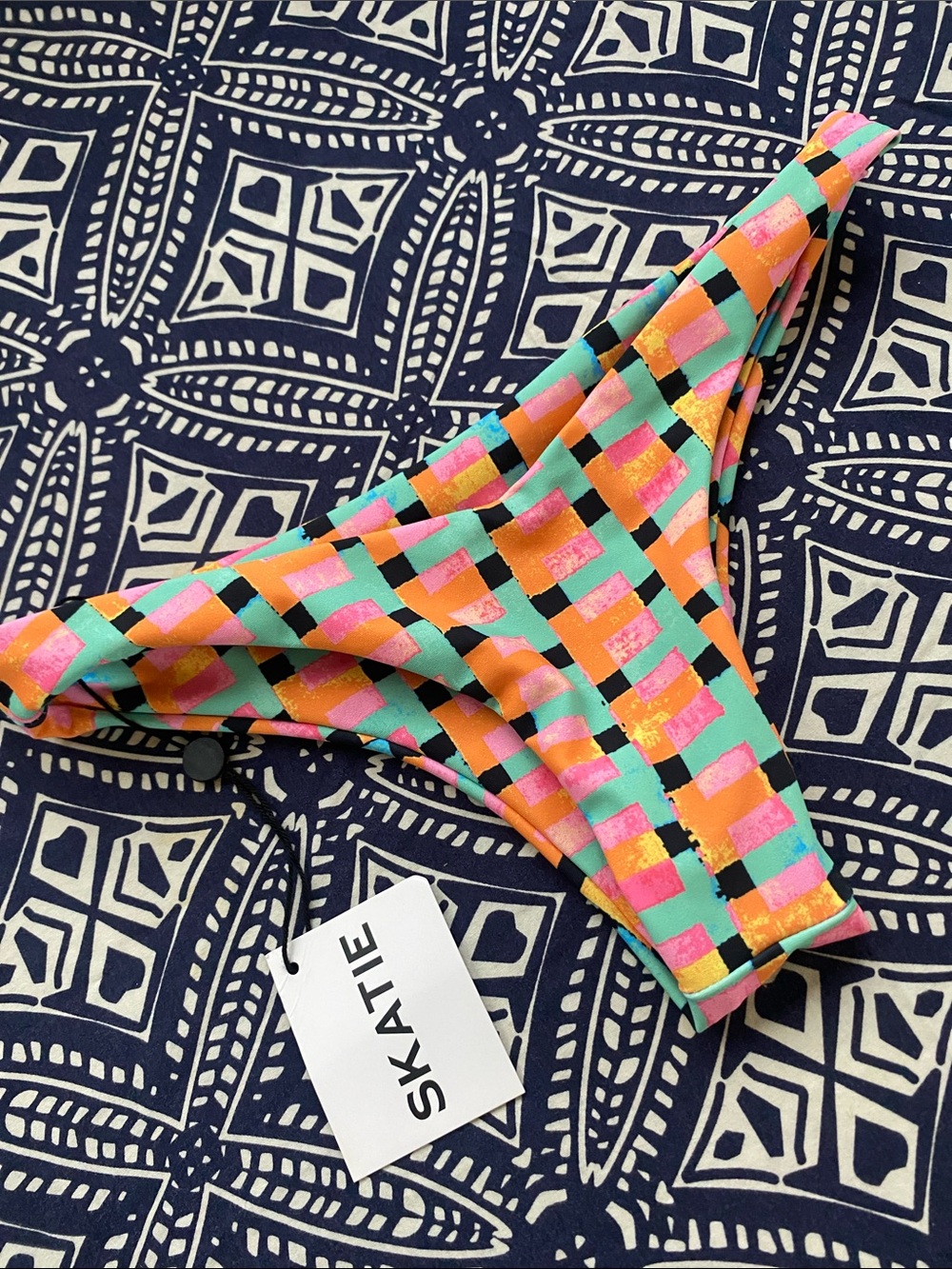 Skatie 'Melly' bikini bottoms in a colorful checkered "RADICAL" print